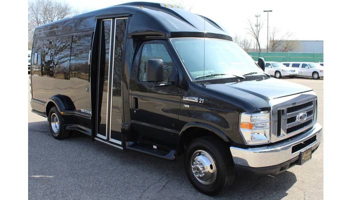 A black van with a door open is parked in a parking lot.