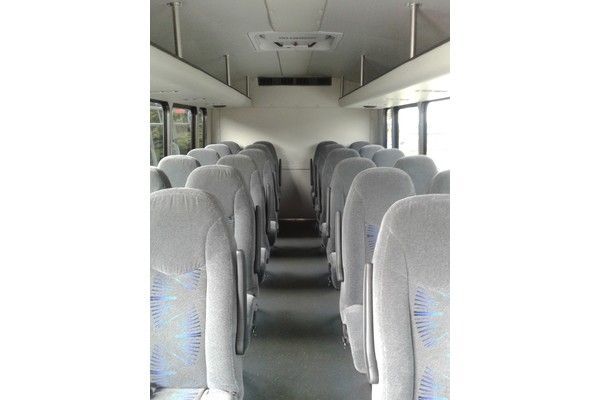 The inside of a bus with a lot of seats