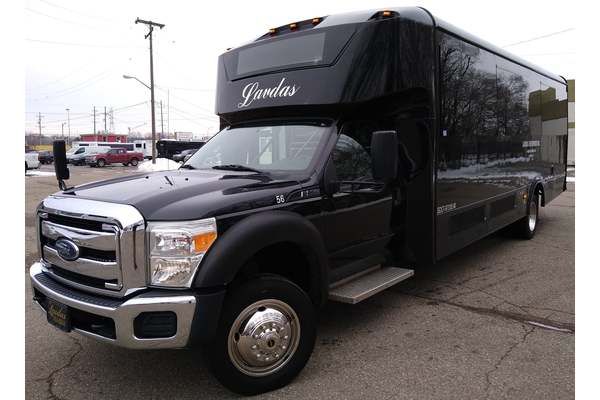 A black ford truck is parked in a parking lot.