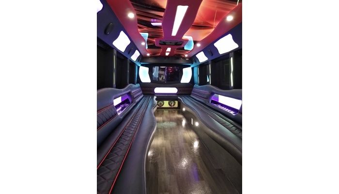 The inside of a limousine with a bowling alley in the background.