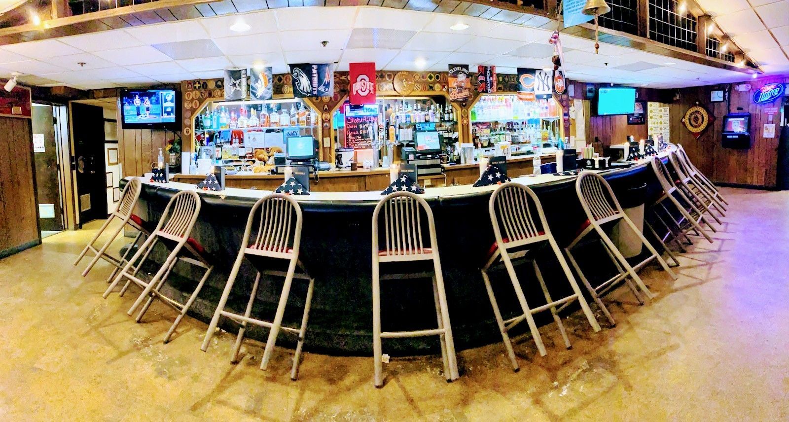 Service members in blue uniforms line up at a holiday-decorated serving station while staff serve food.