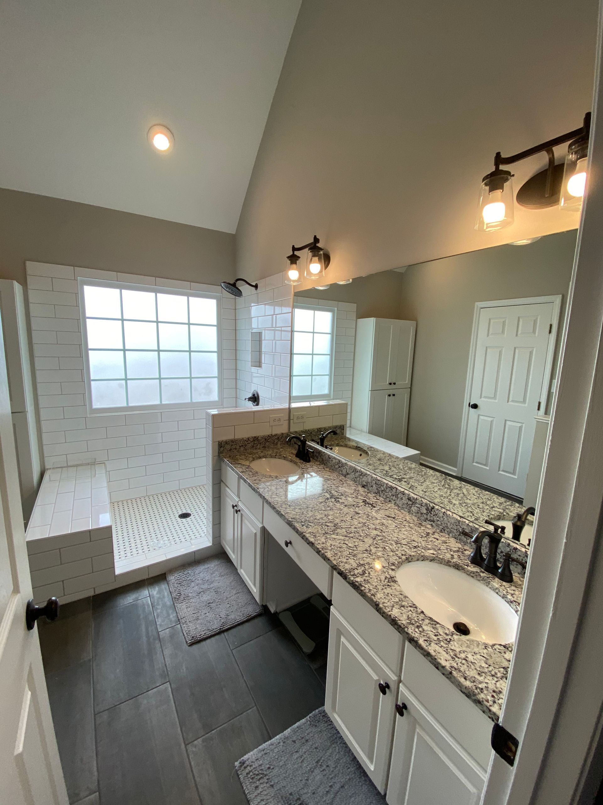 The same kitchen with the previously brown cabinets painted white and grey.