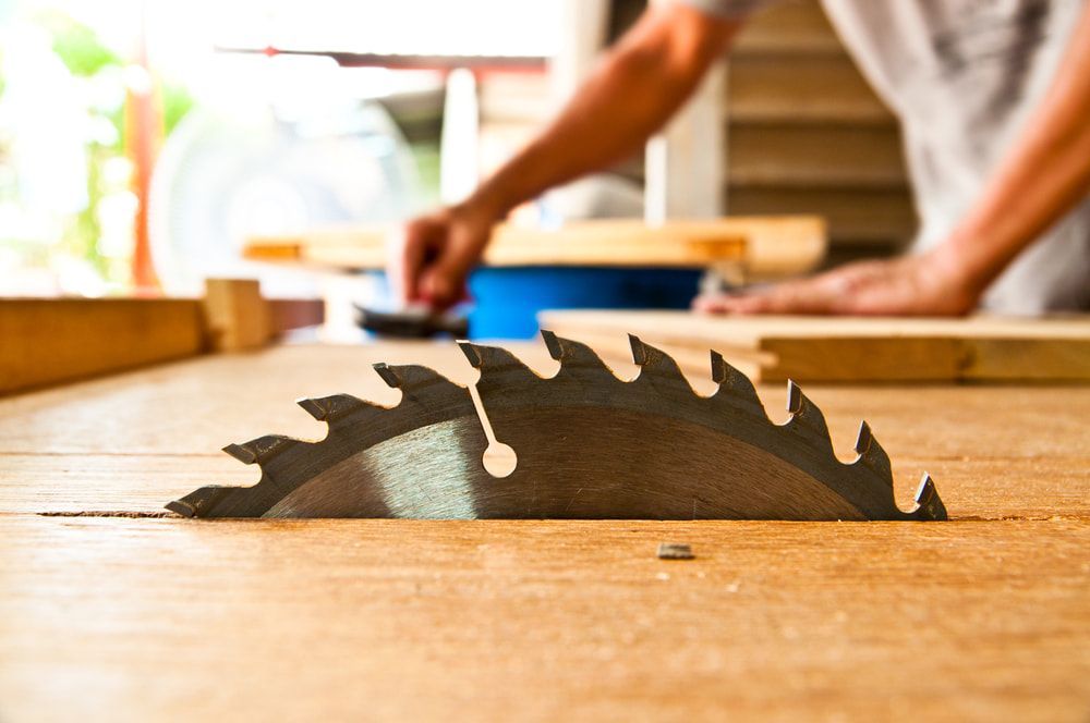Close Up of a Circular Saw Blade on a Wooden Table — Ken Willis Joinery Pty Ltd In South Grafton, NSW