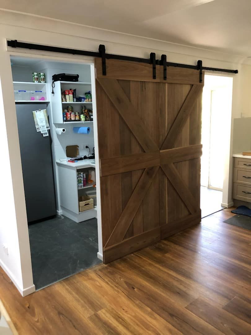 A Kitchen With a Sliding Barn Door Leading to a Pantry — Ken Willis Joinery Pty Ltd In South Grafton, NSW