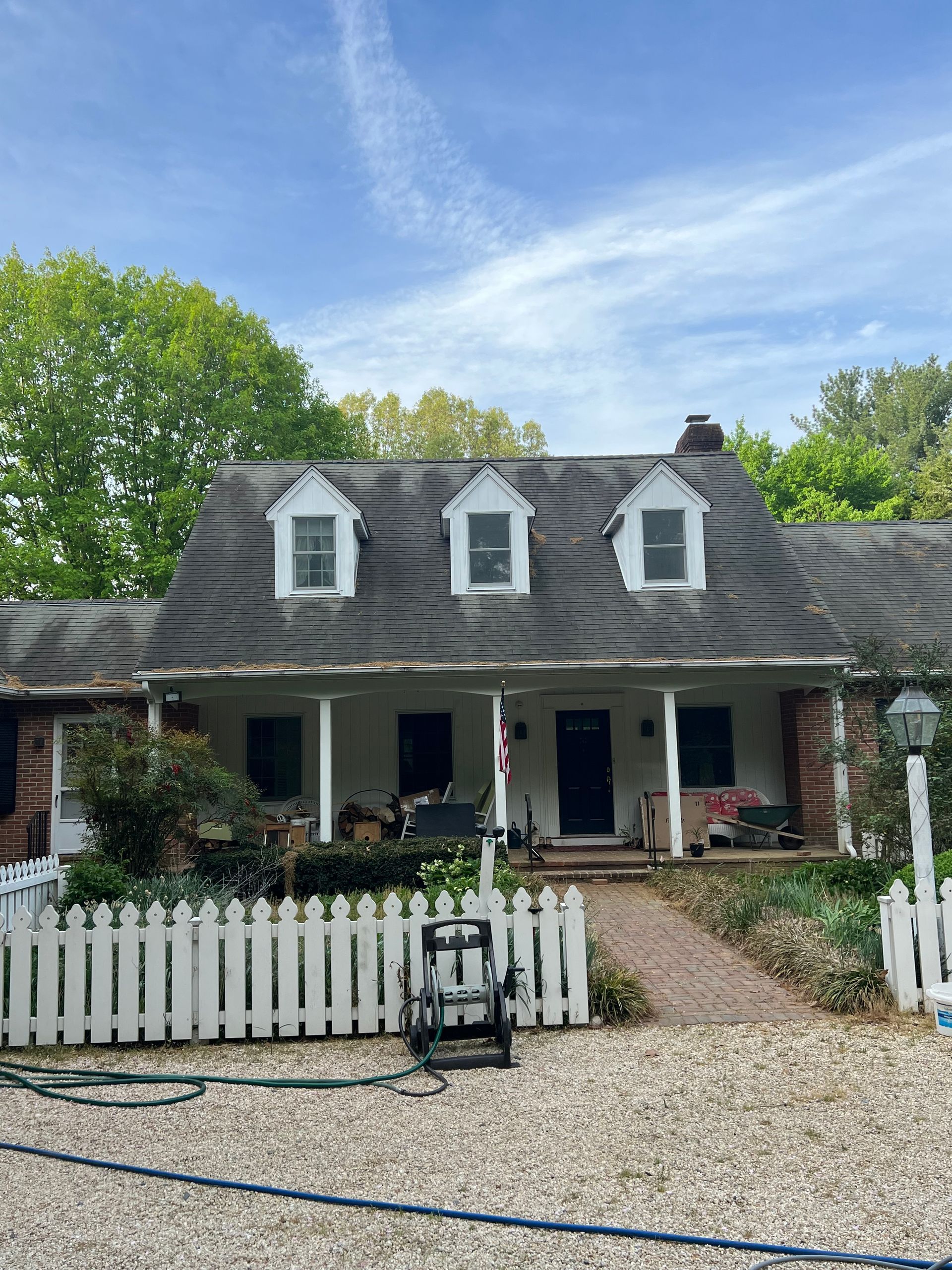 A house with a white picket fence in front of it