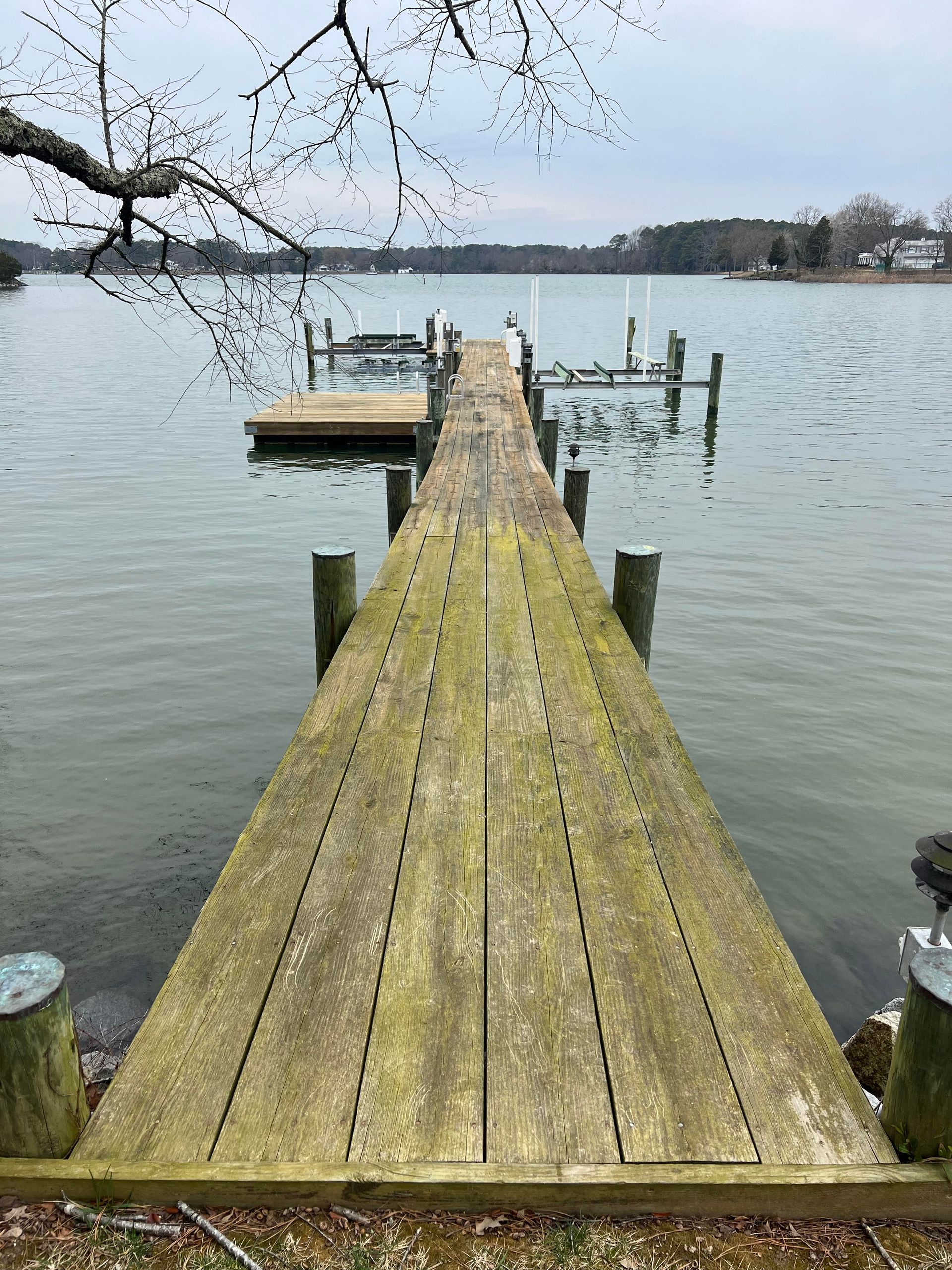 A wooden dock leading into a large body of water.
