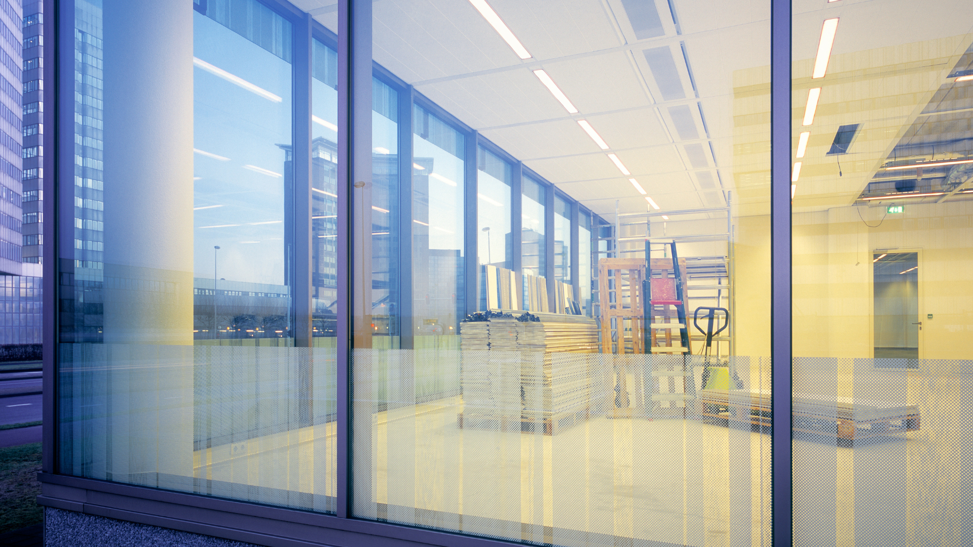a large empty room in a building under construction .