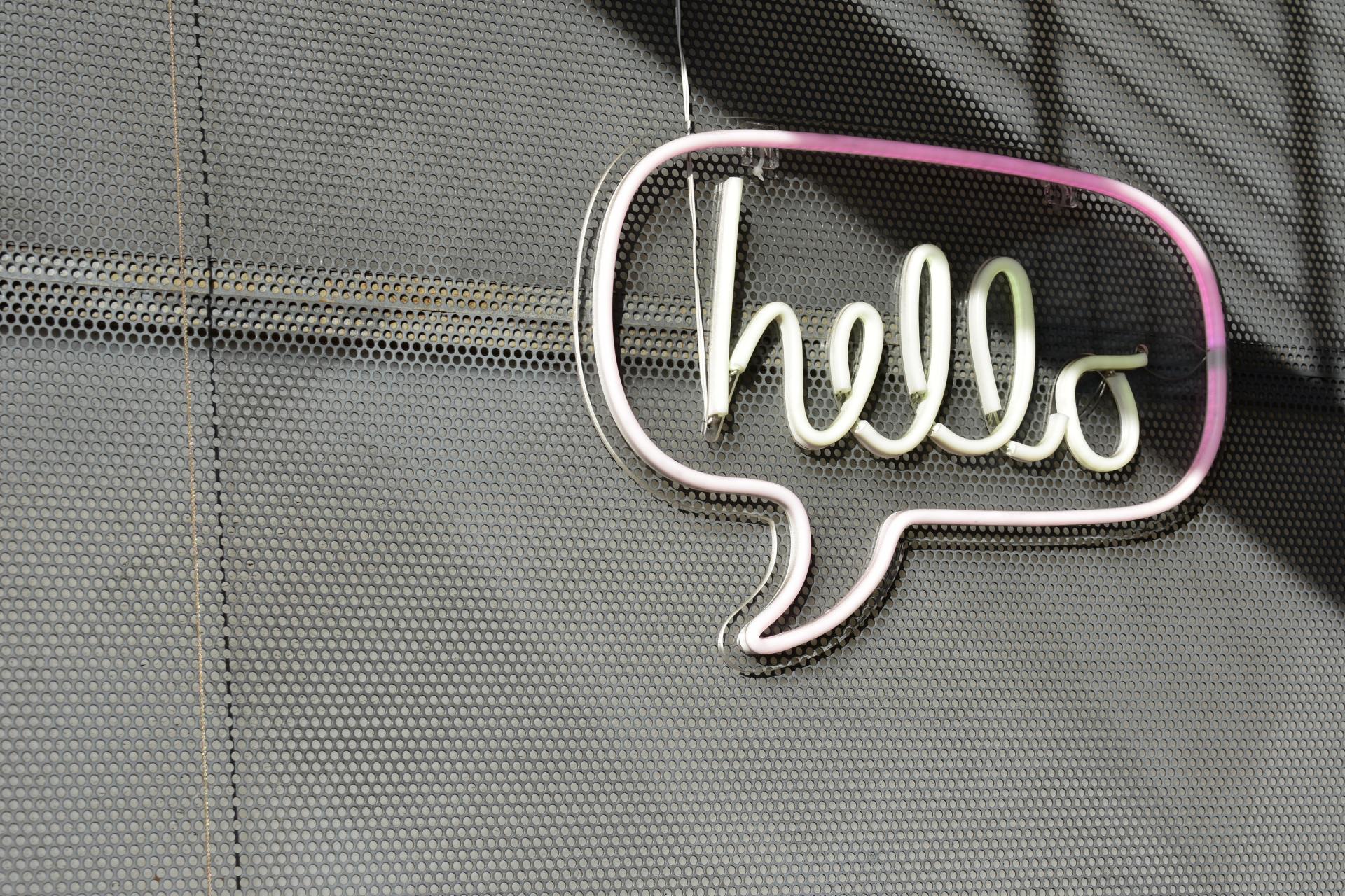 A wire speech bubble with the word hello written inside of it.