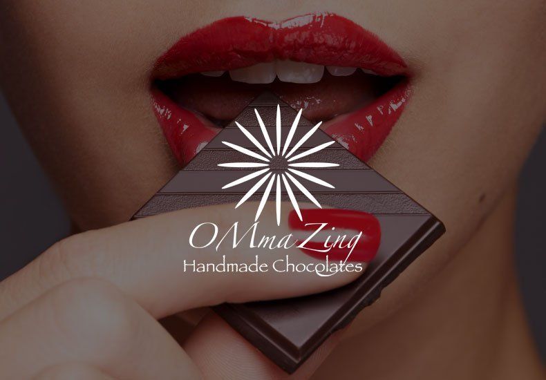 A woman with red lips is biting into a bar of chocolate
