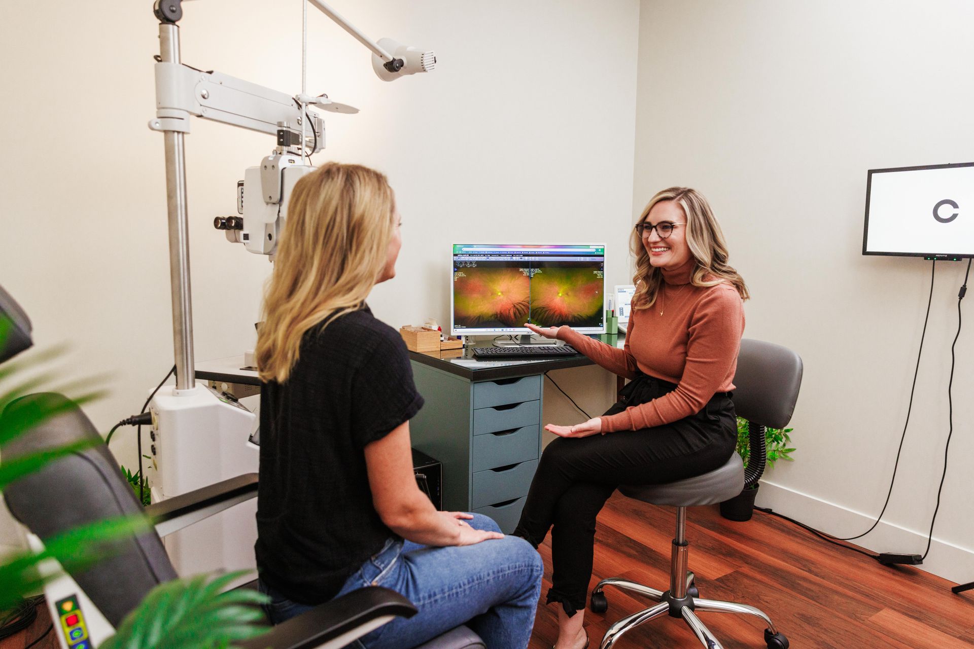 Doctor showing patient retinal imaging