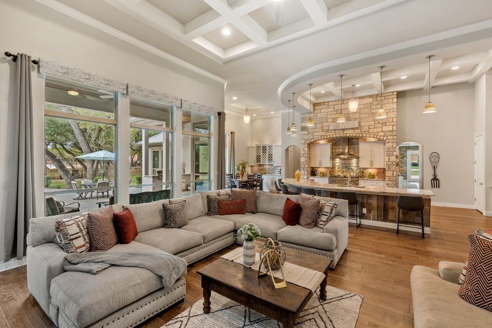 A living room with a large sectional couch and a coffee table.