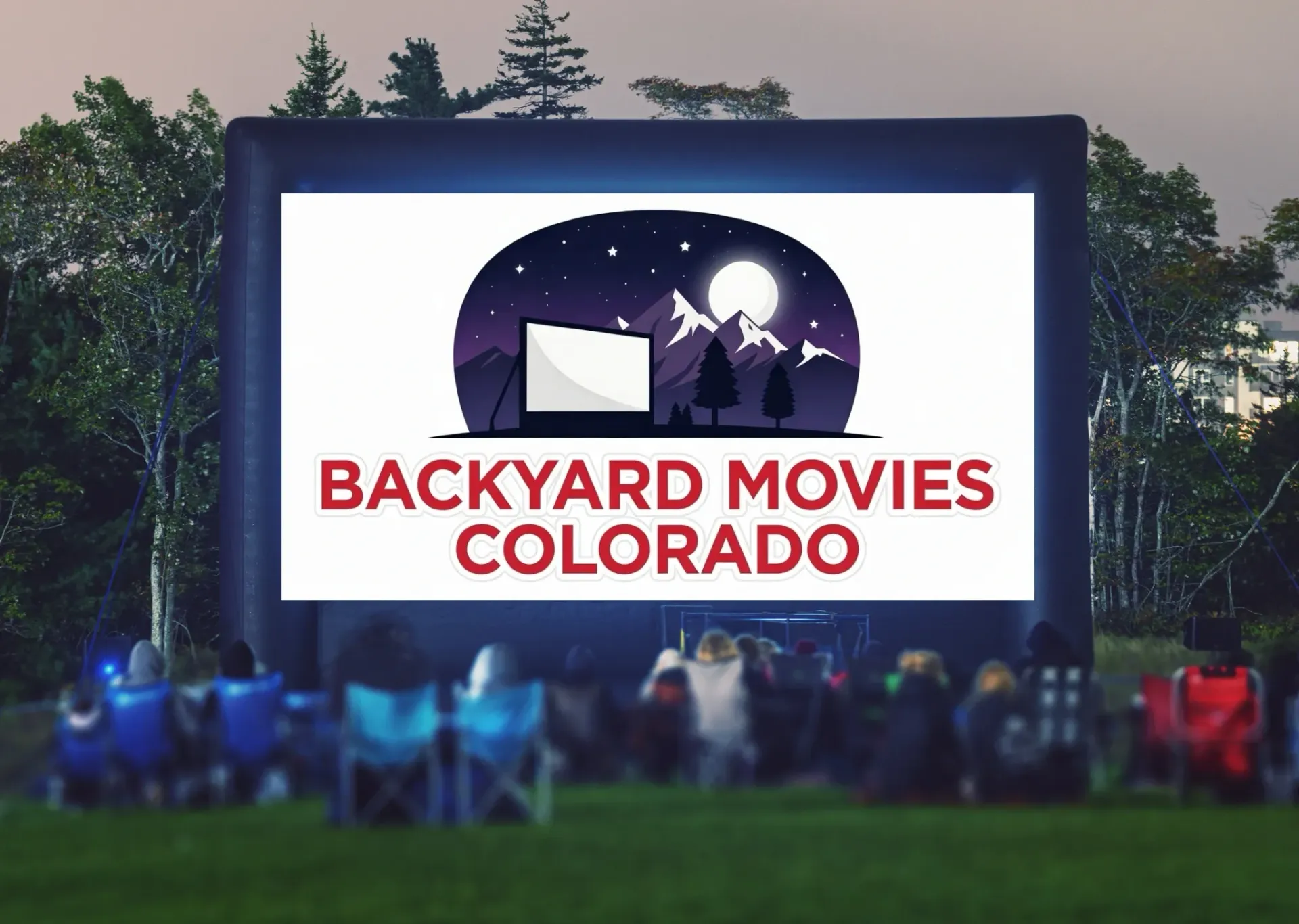 An inflatable movie screen rental set up in a backyard in Denver, CO with a screen that says welcome to movie night.