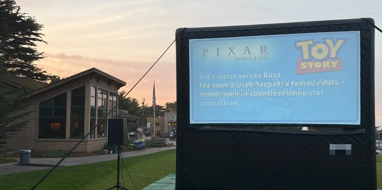 A pixar movie is being shown on a large screen