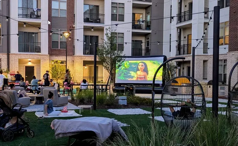 Guests watching a movie on an inflatable screen at an outdoor resort viewing area in Lone Tree, Colorado