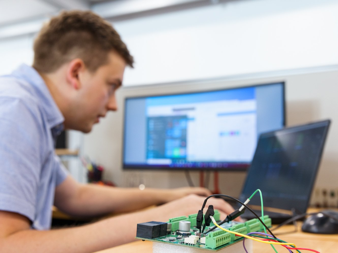 Electronic engineers testing software and hardware.