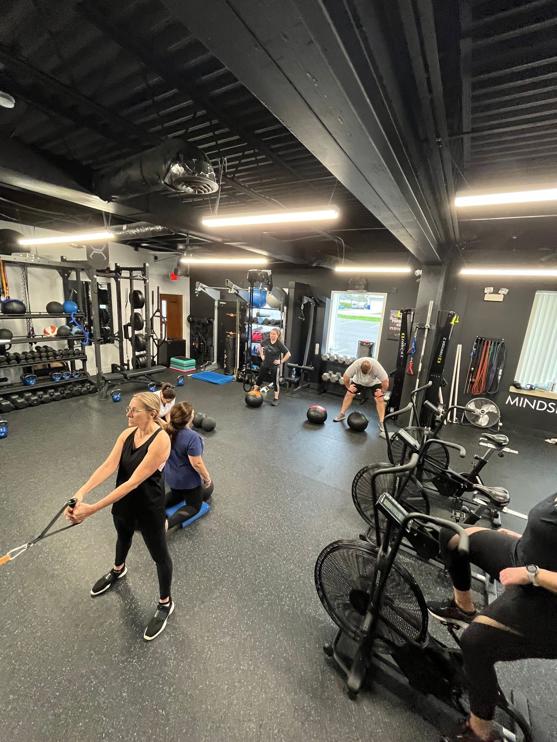 A group of people are working out in a gym.