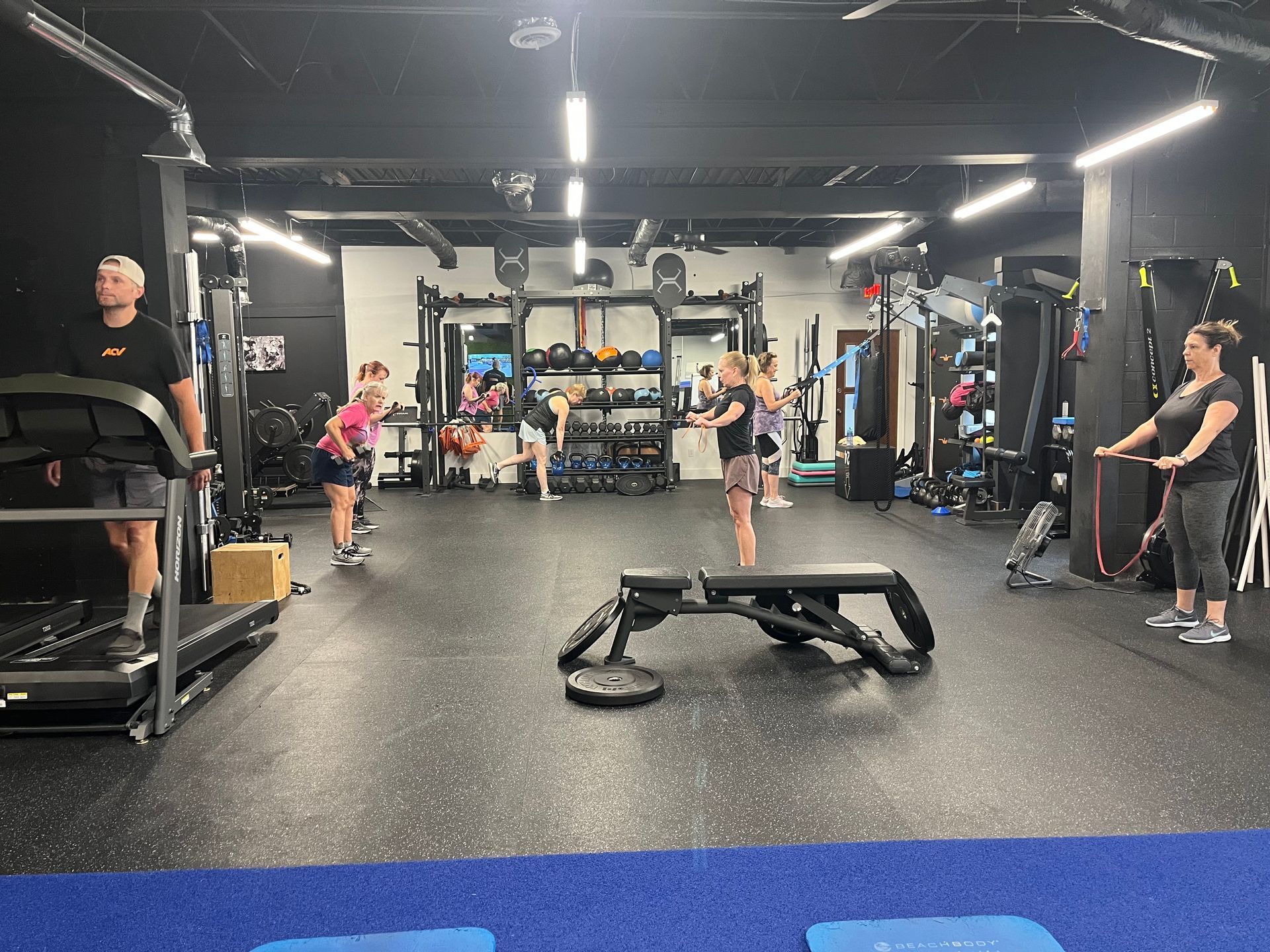 A group of people are working out in a gym.