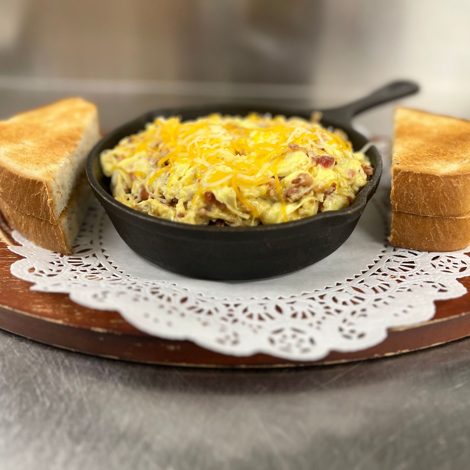 There is a plate of french toast and eggs on the table.