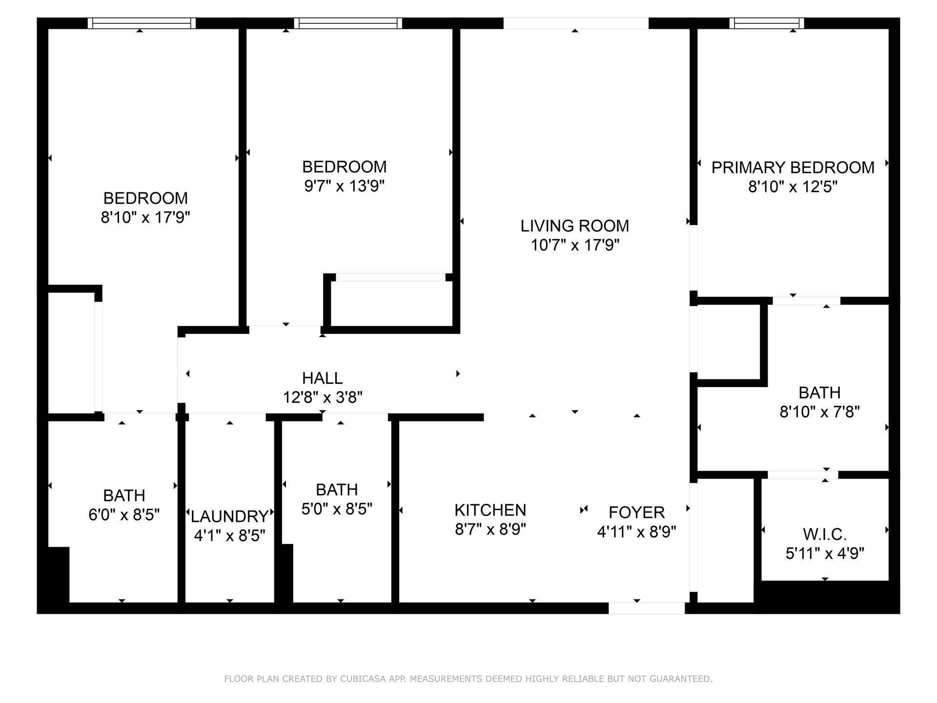 Floor plan of an apartment with a living room, kitchen, three bedrooms, two bathrooms, a hall, a laundry area, and a foyer.