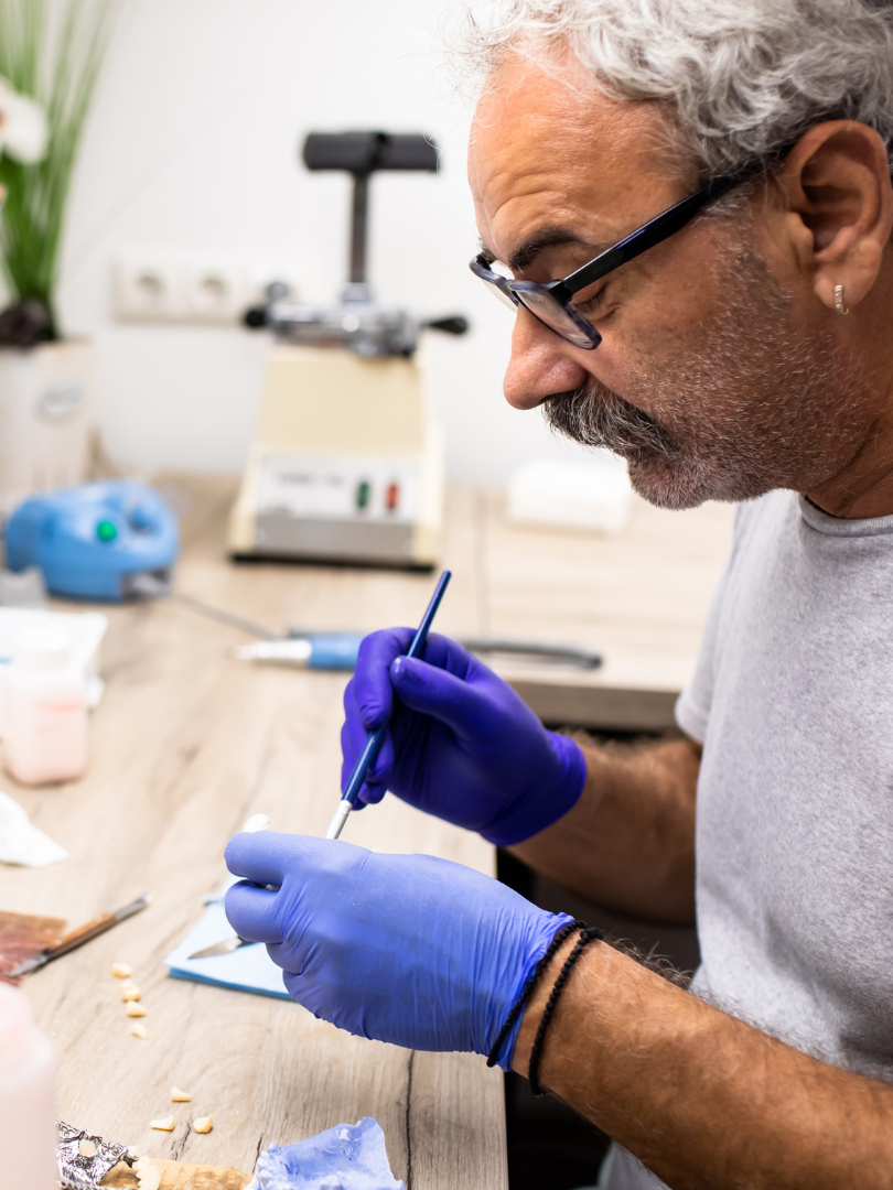 A woman is getting her teeth examined by a dentist.