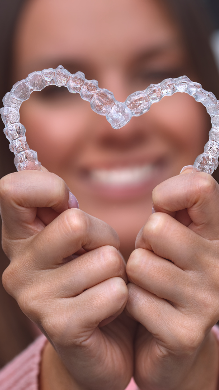 A woman is getting her teeth examined by a dentist.