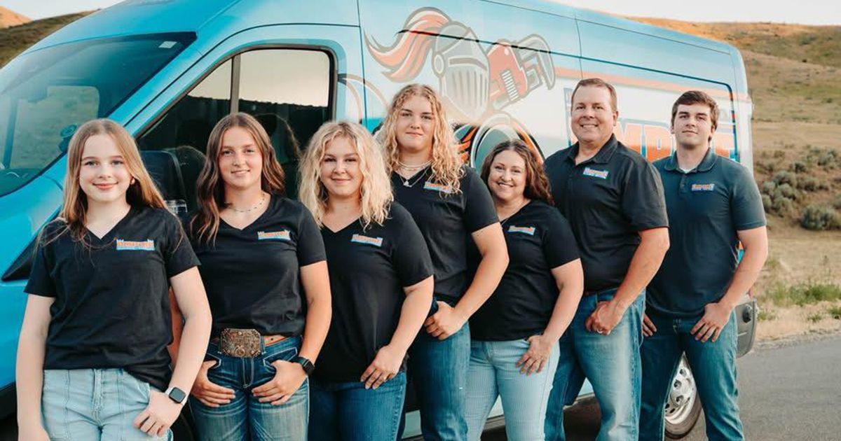 Hand holding a pressure gauge connected to irrigation pipes; gauge reads 45 kPa.