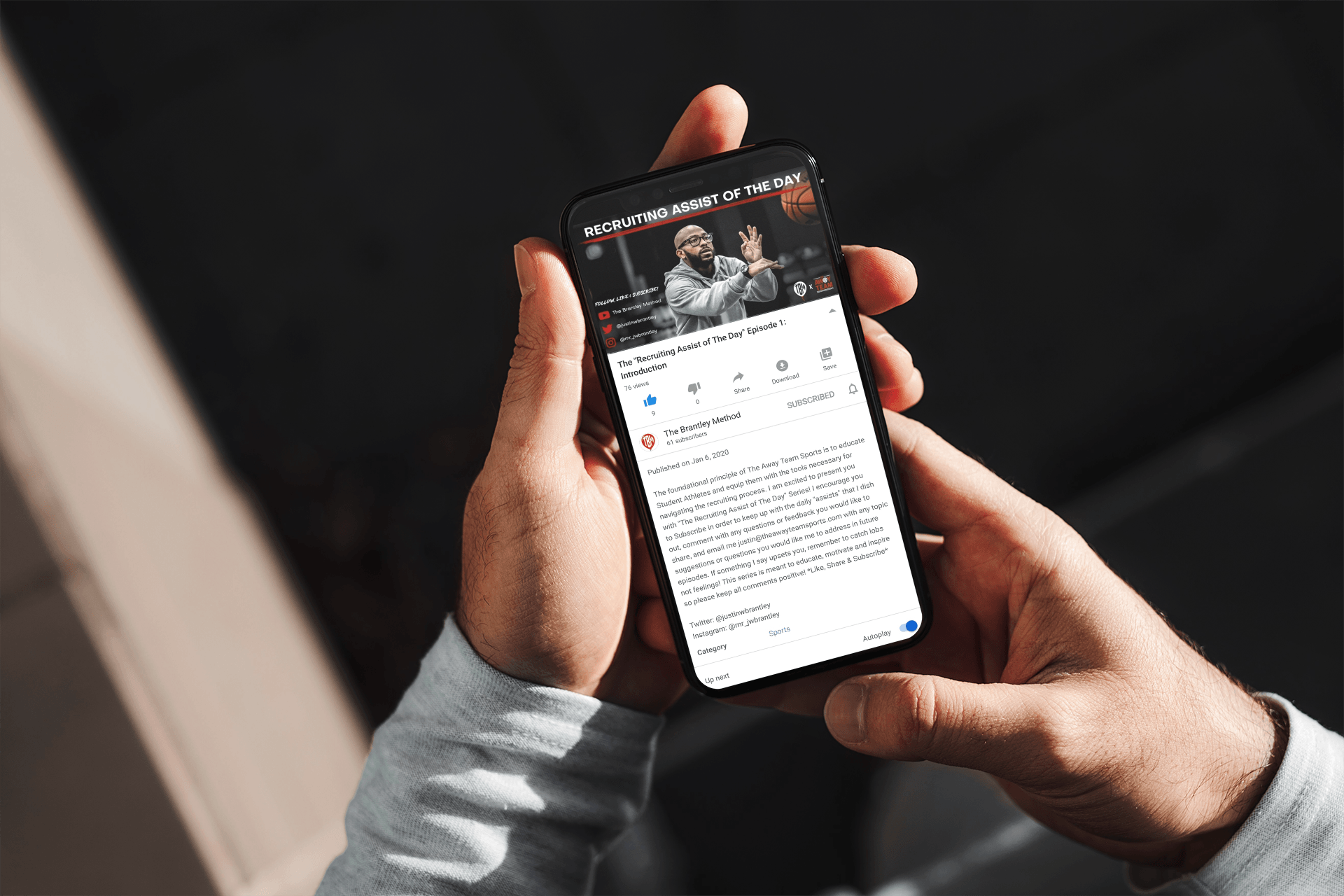 A person is holding a cell phone in their hands.