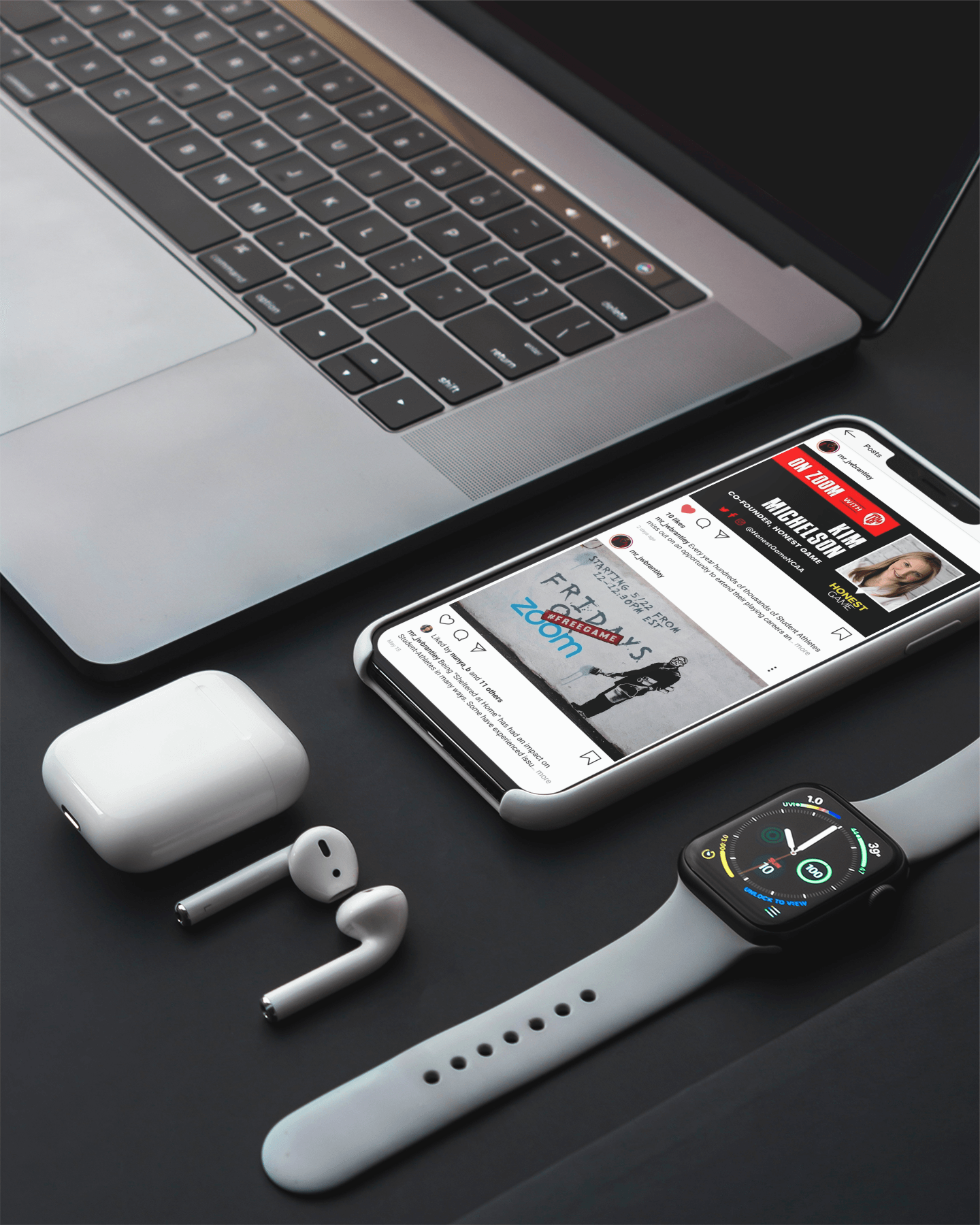 A cell phone sitting on top of a laptop next to a watch and ear buds