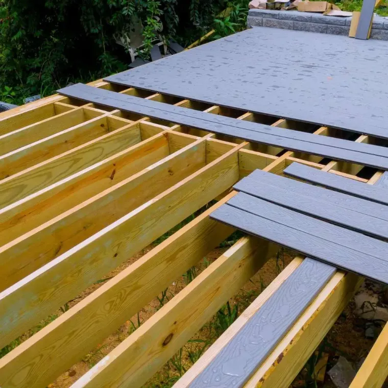 A wooden deck under construction with a gray roof