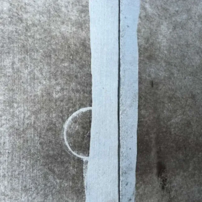 A close up of a piece of wood on a concrete surface.