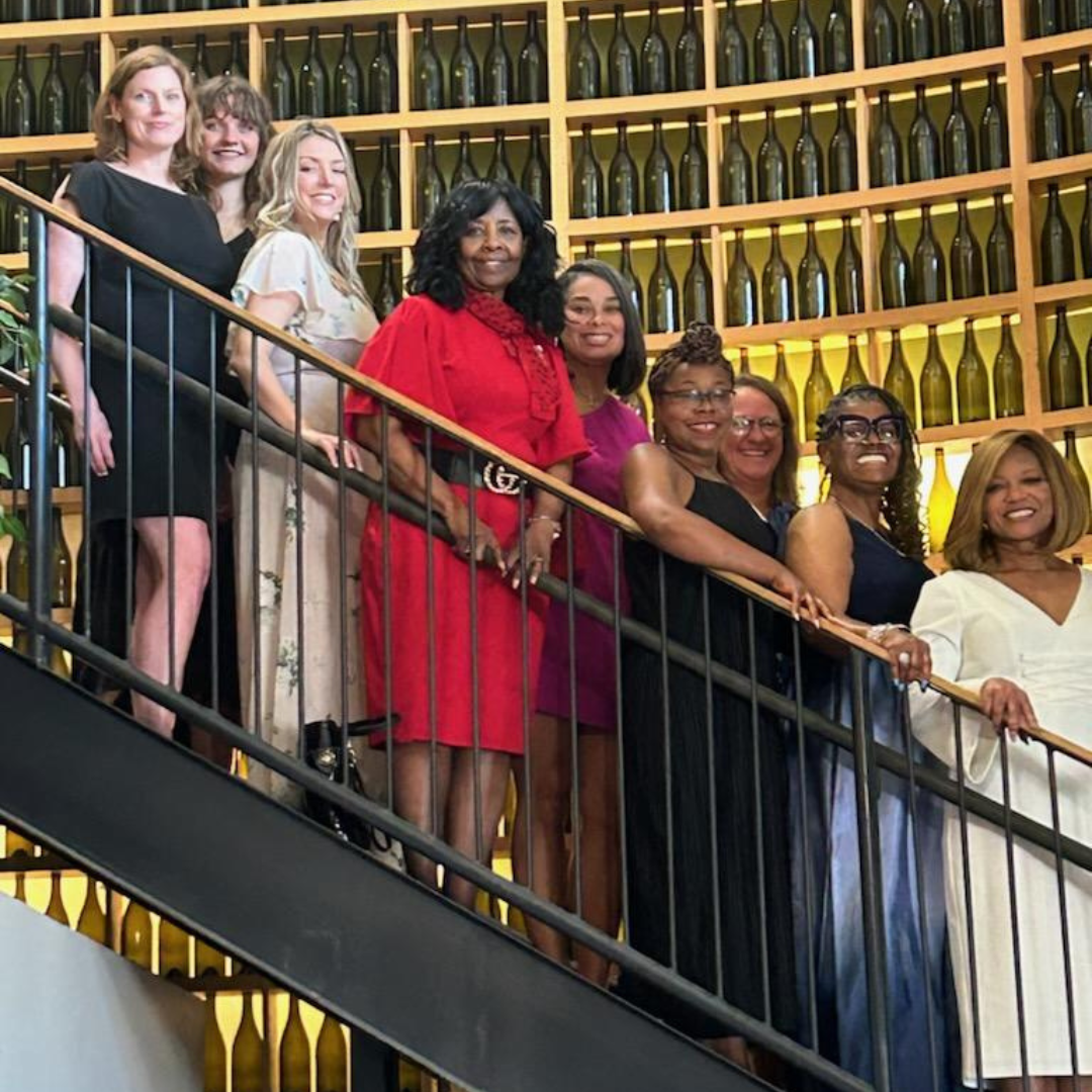 A group of women are standing on a set of stairs.