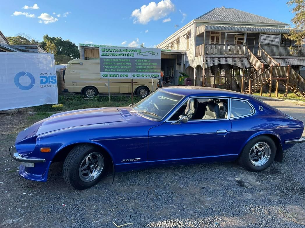 A Blue Car Is Parked In Front Of a Building That Says South Coast Automotive — Mechanic in Lismore, NSW