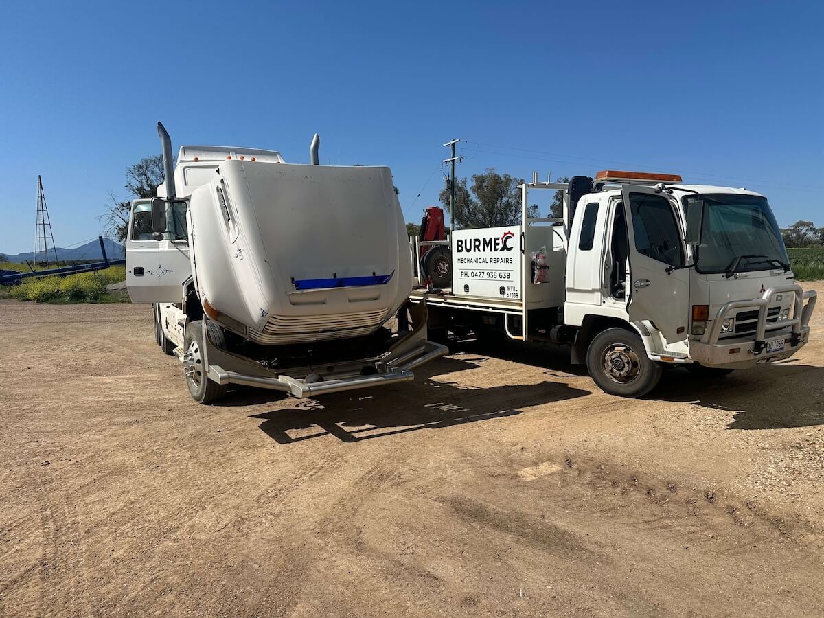Two tow trucks are parked next to each other in a dirt lot — Burmec In Narrabri, NSW