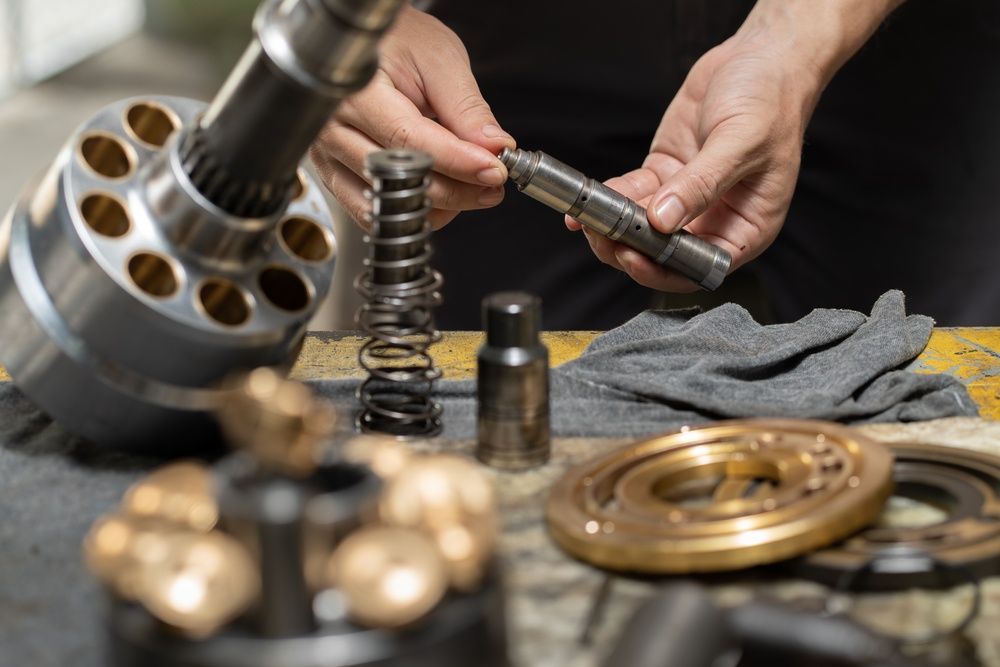 A Person is Working on a Piece of Metal on a Table — Burmec In Narrabri, NSW