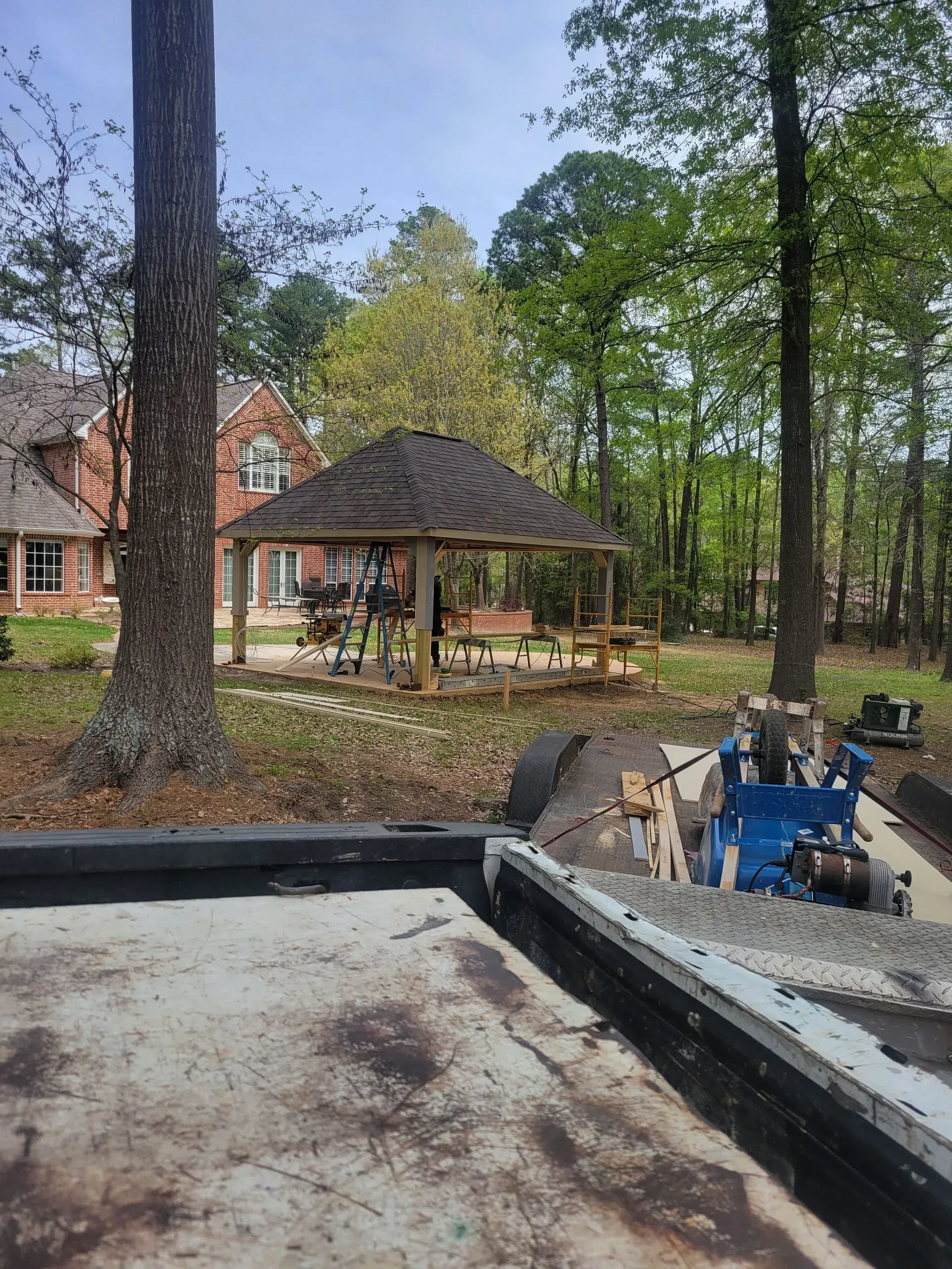 A house with a gazebo in the backyard is being built