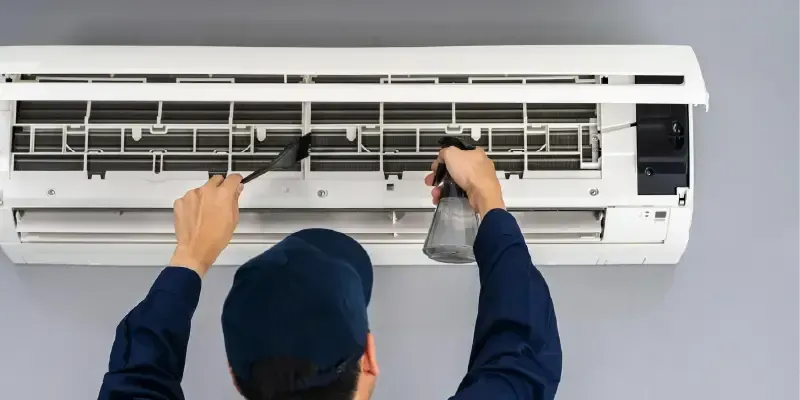 Man Doing Ductless AC Unit Maintenance