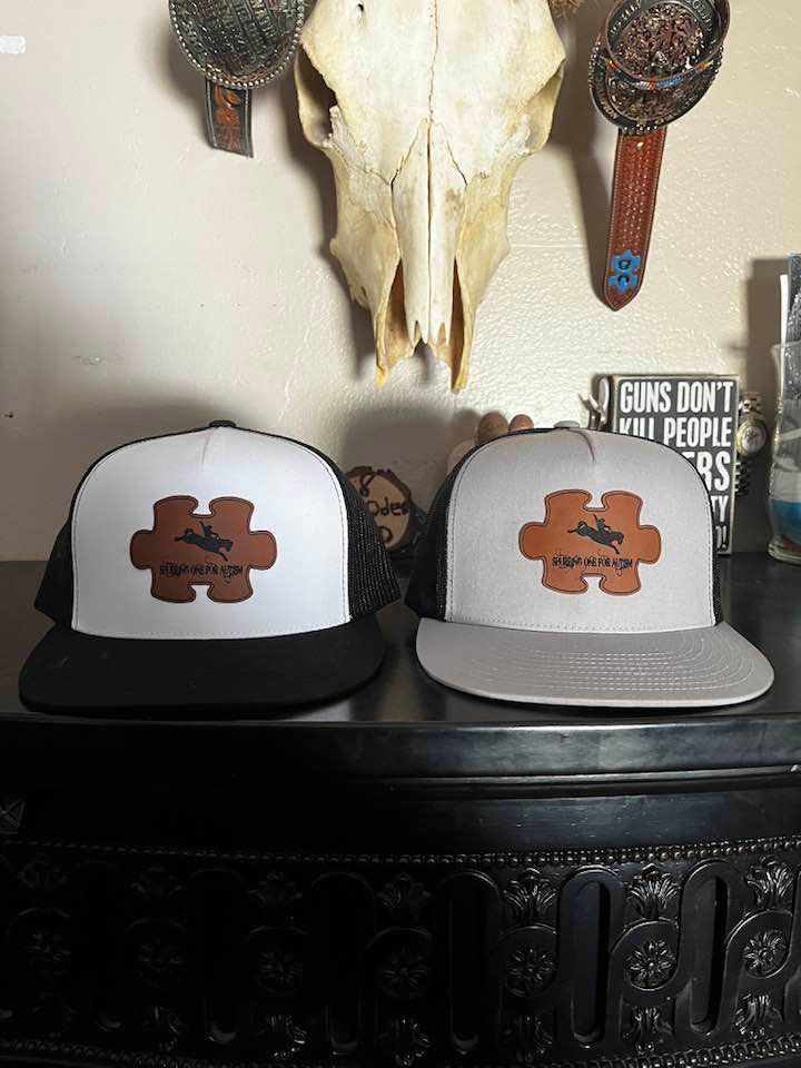 2 spurrin one for autism baseball caps