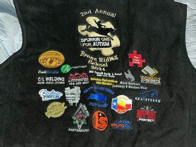 A black vest that says 2nd annual on it