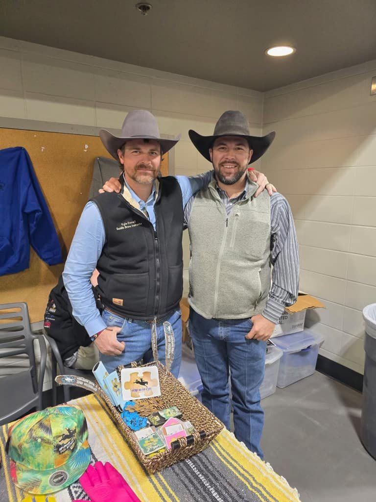 Two men wearing cowboy hats are standing next to each other in a room.