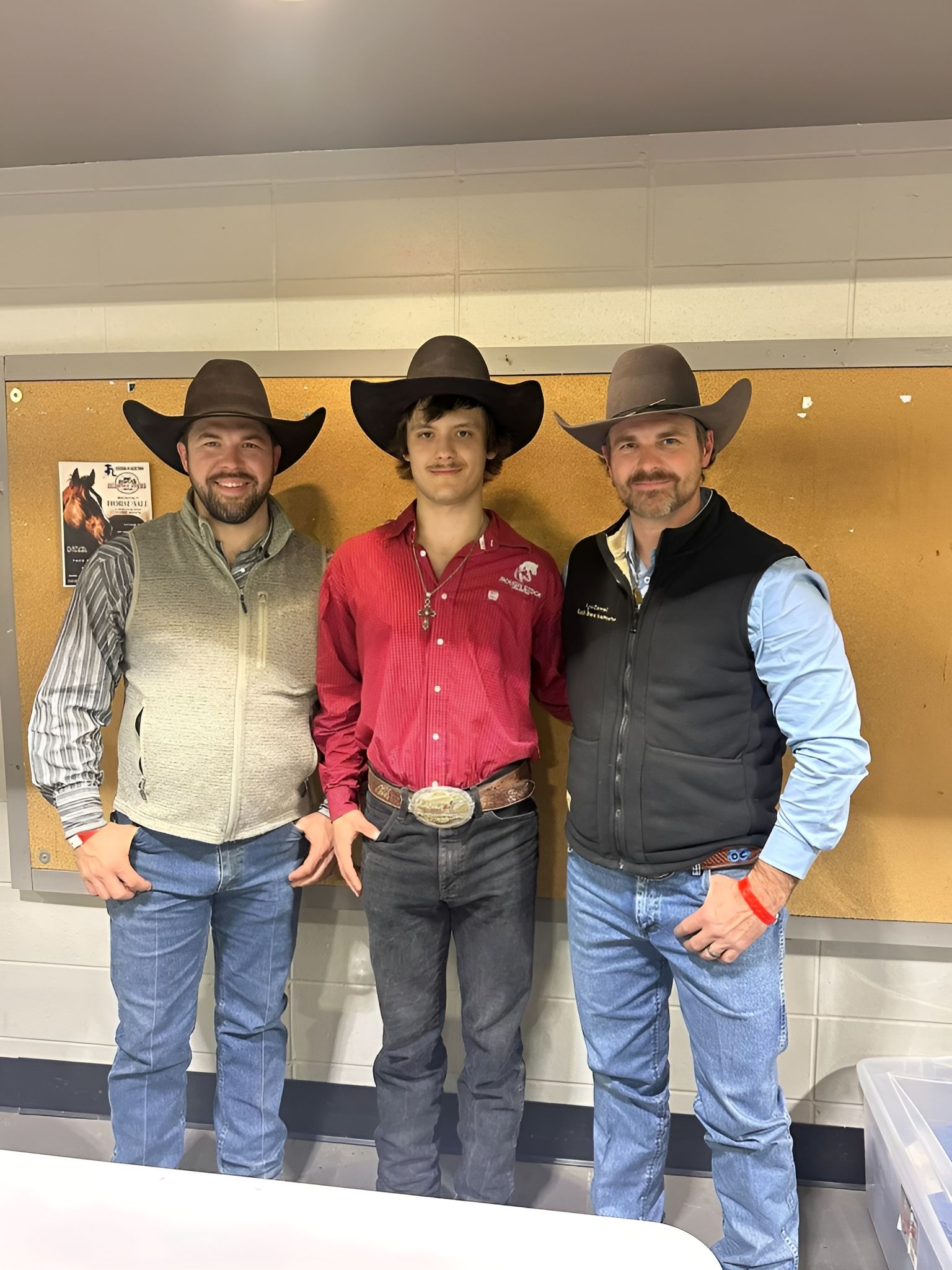 Three men wearing cowboy hats are posing for a picture.