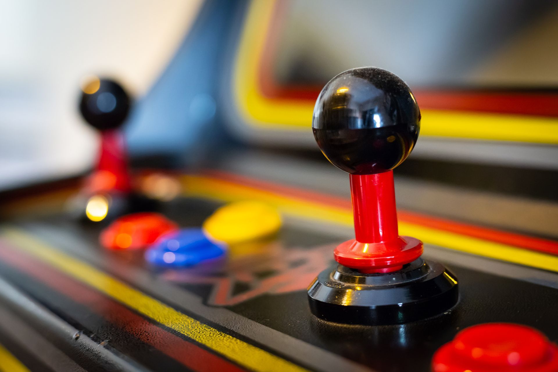 A close up of a video game controller on an arcade machine.