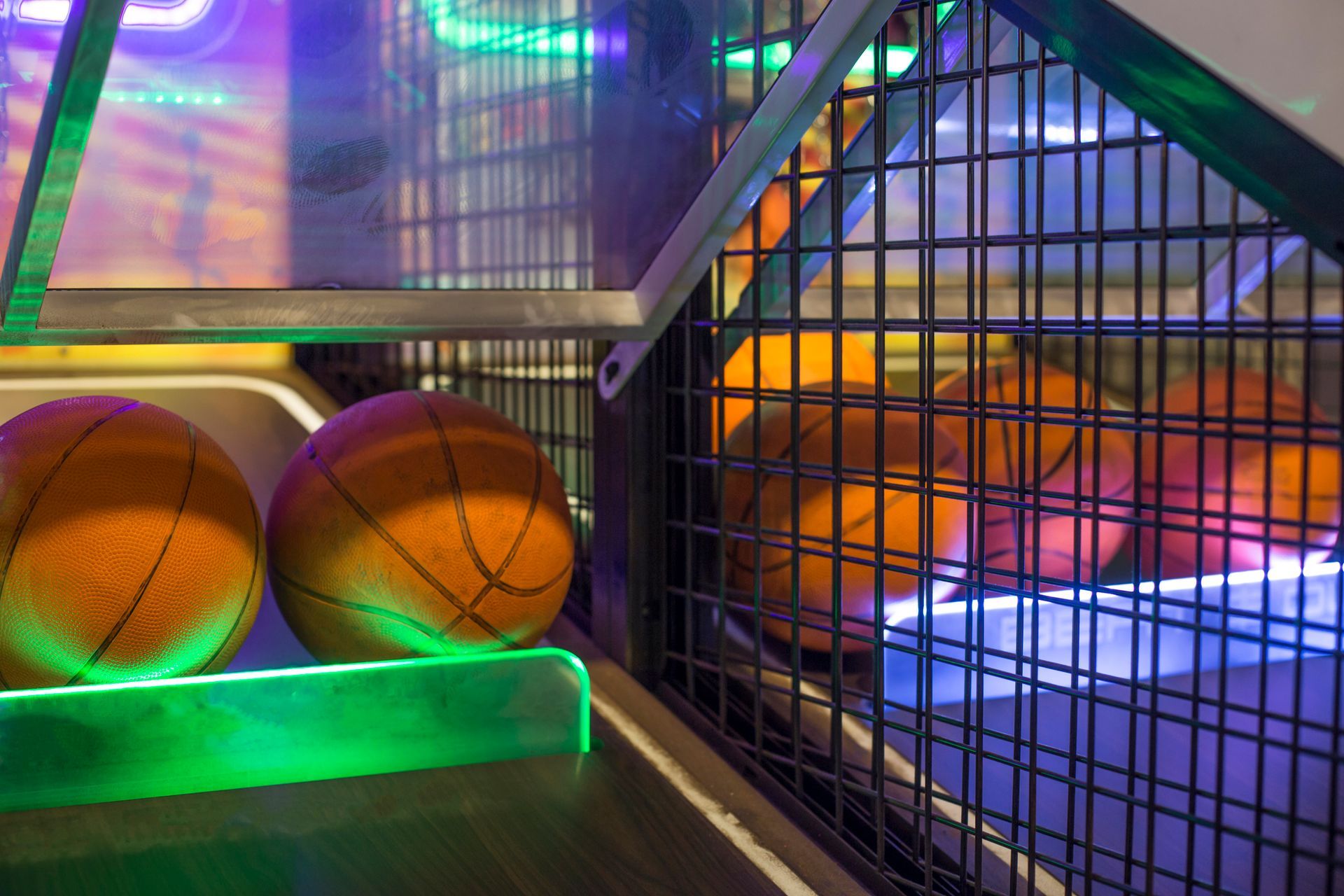 A couple of basketballs sitting on top of a basketball hoop.