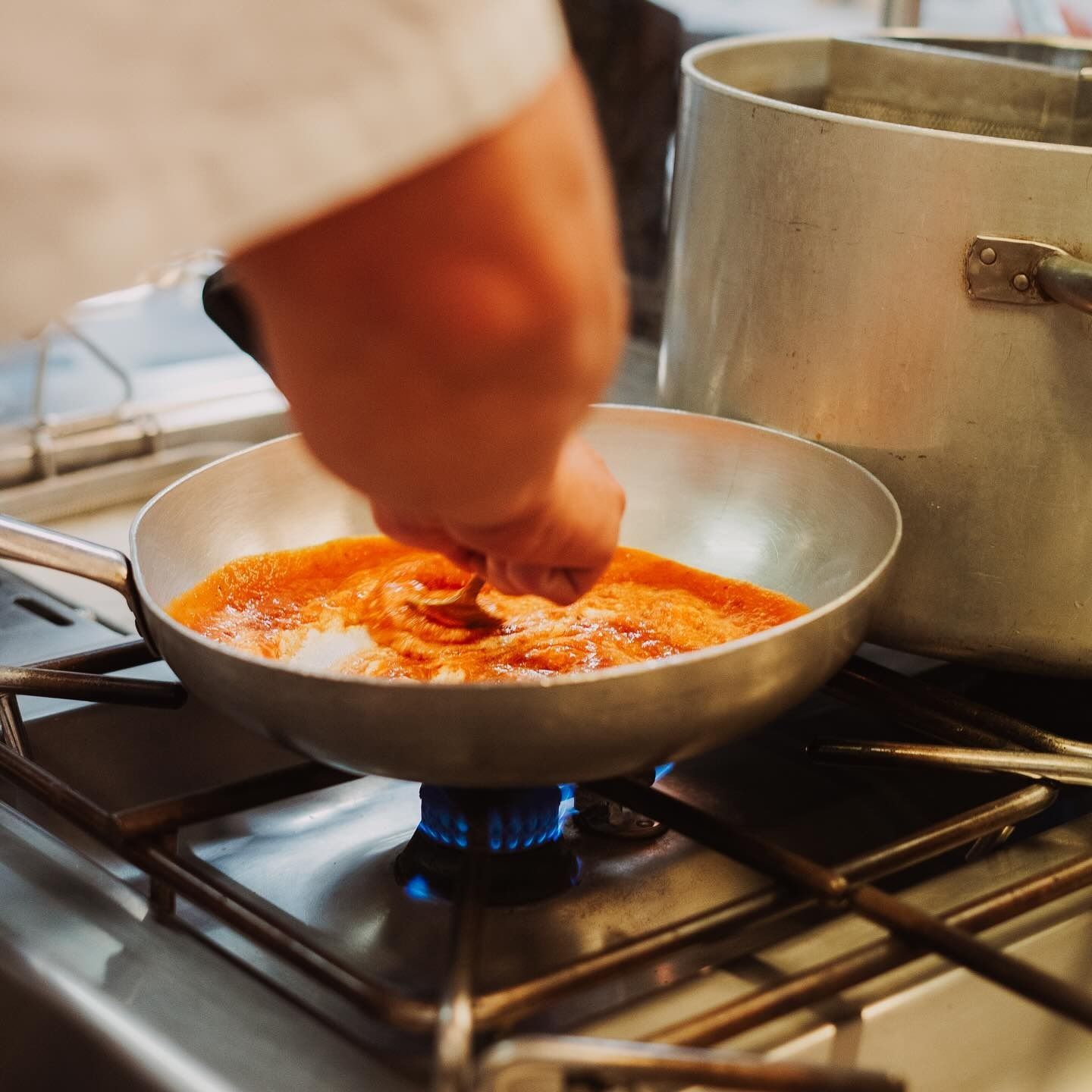 Tagliere di salumi con carni, formaggi, frutta, verdura e salse su una superficie di legno.