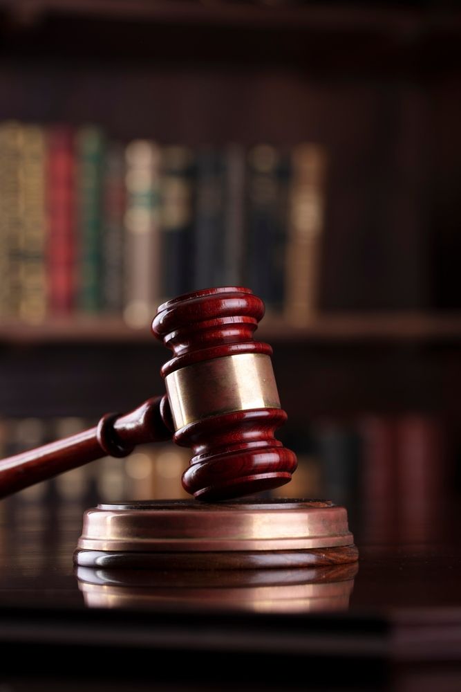 Law and justice symbols on library background - Lawyer in Woy Woy, NSW