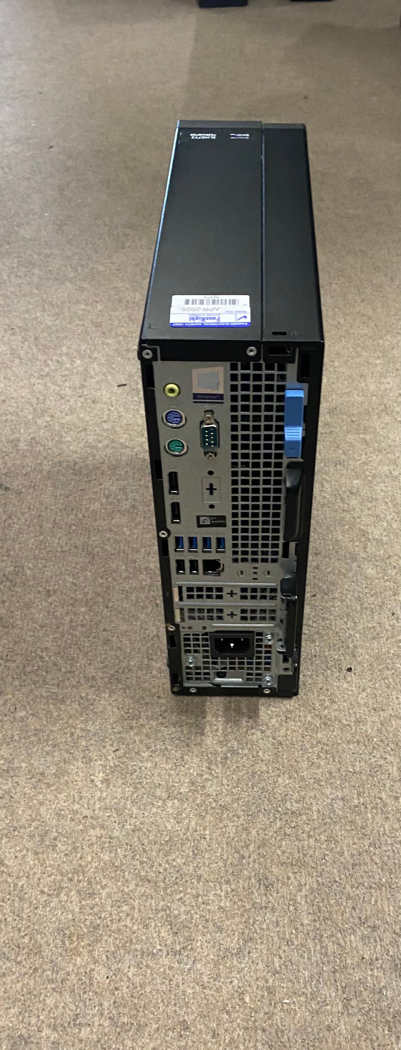 Black Dell desktop computer on a carpeted floor.