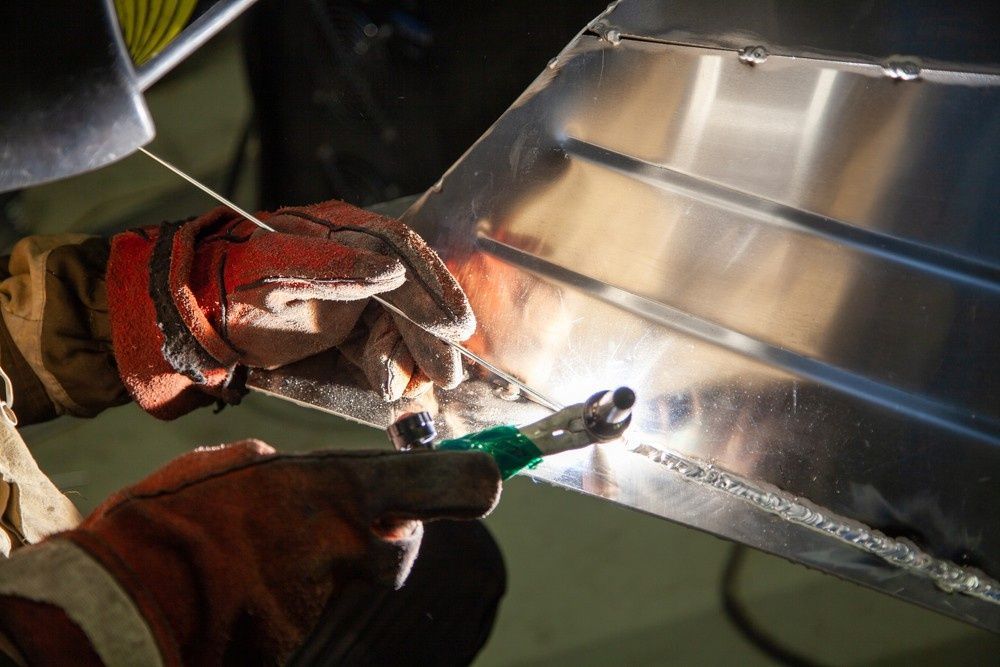 A Person Welds Metal with A Bright Arc, Wearing Gloves and A Welding Helmet — SAE Engineering in Tablelands, QLD