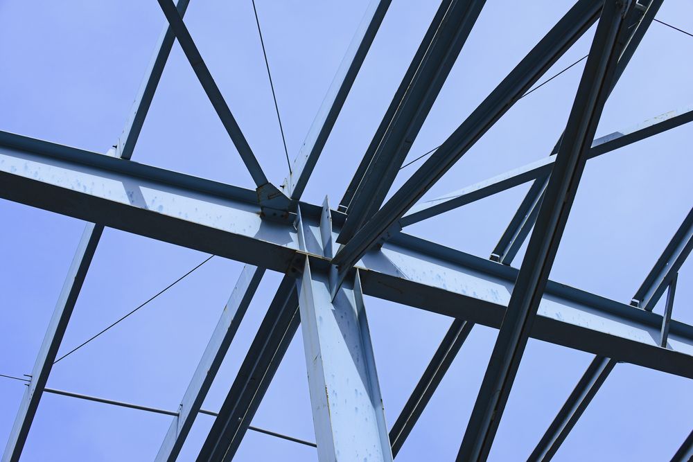 Blue Steel Beams Form The Skeletal Structure Of A Building Against A Clear Sky — SAE Engineering in Mount Sheridan, QLD
