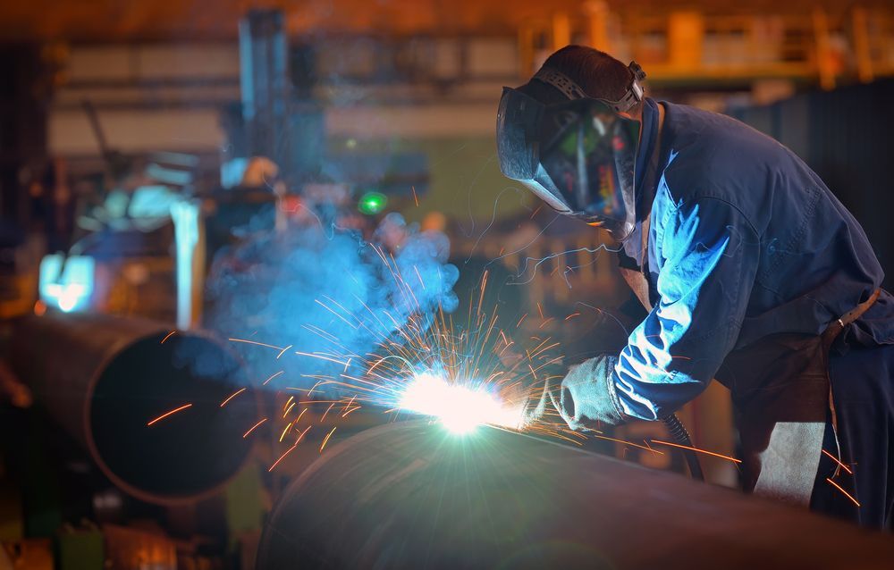 Welder In A Dark Setting, Sparks Flying From A Metal Pipe — SAE Engineering in Mount Sheridan, QLD
