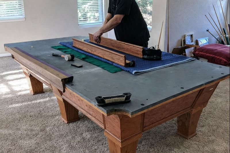 Team member assembling a pool table