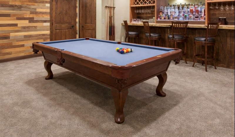 Woman and older woman smiling, indoors. Woman in red shirt, other in navy blazer.